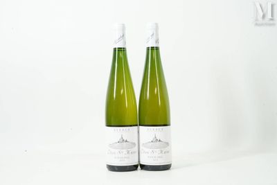 two bottles of wine sitting next to each other on a white surface