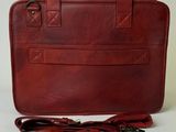 an image of a brown leather briefcase with a leather strap