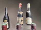 three bottles of wine on display on a clear shelf