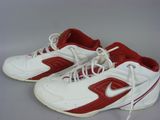 pair of white and red sneakers with laces on a gray surface