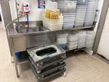 a kitchen with a lot of dishes on the counter