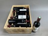 bottles of wine in a wooden box on a table