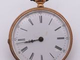 a gold pocket watch with roman numerals on the face