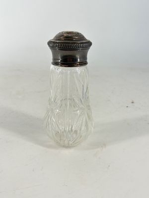 an antique glass salt and pepper shaker with a silver lid