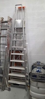 a ladder that is leaning against a wall next to a keg