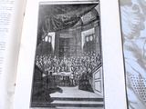 an open book with a picture of a large group of people sitting at a table