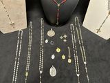 a group of necklaces and bracelets on display on a table