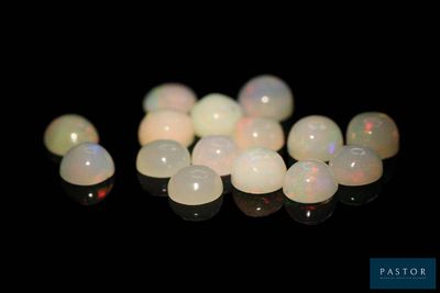 some white oplites on a black surface with a black background