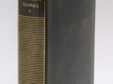 an old book sitting on top of a table next to a white background