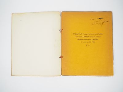 an open book sitting on top of a white table next to a white wall
