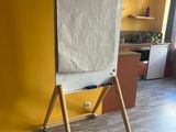 a white board on a wooden stand in a yellow room