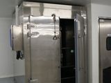 a large stainless steel freezer in the middle of a room