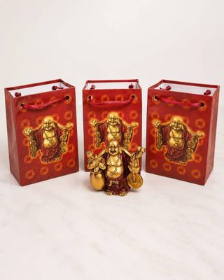 three red bags with gold decorations on them sitting next to each other