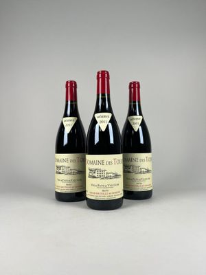 three bottles of wine sitting on top of a table