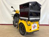 a yellow motorcycle with a black box on the back of it