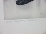 a black and white photo of a dog ' s paw in the snow