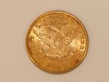 an image of a gold coin on a white surface