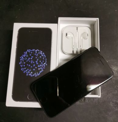 an image of a cell phone in a box with earphones
