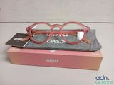 glasses in a box on a table with a book and a pair of glasses