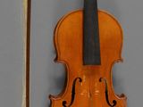 an old violin with a bow and a bow rest on a wall