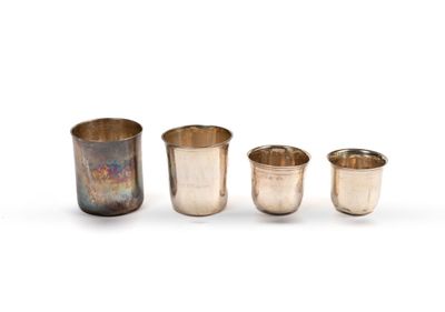three silver cups and a silver beakle on a white background