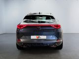 the rear end of a grey car in a white room
