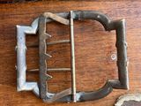a metal buckle that is attached to a wooden drawer