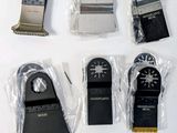 cinq types différents de lames de scie sur une surface blanche