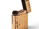 a small wooden box that has a lighter inside of it