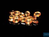 a close up of a bunch of yellow diamonds on a black surface