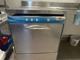 stainless steel dishwasher in a commercial kitchen next to a sink