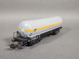 the train car is white and yellow with a yellow stripe on the side