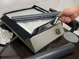 a person that is using a machine to make something