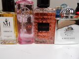 several bottles of perfume are lined up on a table