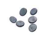 several black stones are arranged in a circle on a white surface