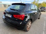 a black car that is parked in a parking lot