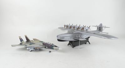 two model airplanes sitting next to each other on a white surface