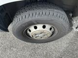 a white car with a flat tire on the street