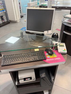 a computer desk with a keyboard and a monitor on it