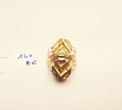 a close up of a gold ring on a white surface with a price tag
