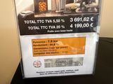 a sign on the table advertising the sale of a tv