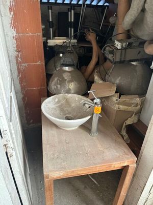a small table with a bowl on it in a room