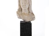 sculpture d'une tête de femme sur un socle en marbre noir