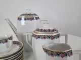 a lot of cups and saucers sitting on a table