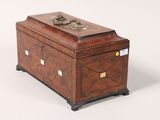 an antique wooden box with brass hardware on top of a white background