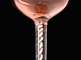 a wine glass with a red and white design on it