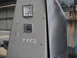 a metal box with a clock on it in a warehouse