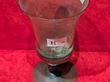 a glass vase that is sitting on a red surface