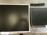 two televisions sitting next to each other on a table