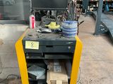 a cart with a bunch of items on it in a garage